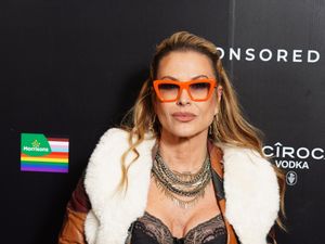 Anastacia wearing a pair of red glasses