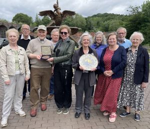 Members of the Friends of the Ironbridge Gorge Museum and of the Trust's Collections team with the plate and medal when they were acquired