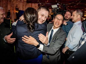 Chairman of Demokraatit, Jens-Frederik Nielsen, hugs supporters during the election party at Demokraatit by cafe Killut in Nuuk