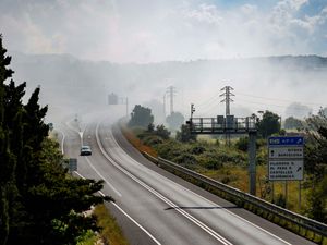 A toxic cloud blots out a road