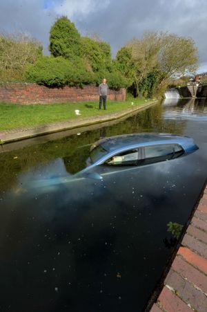 Kevin Davenport looking at the car dumped in the Brierley Hill canal