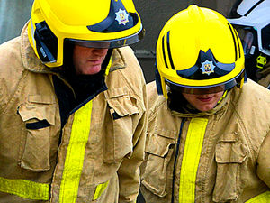 Supporting image for story: Person helped by ambulance crews after car overturns on rural road