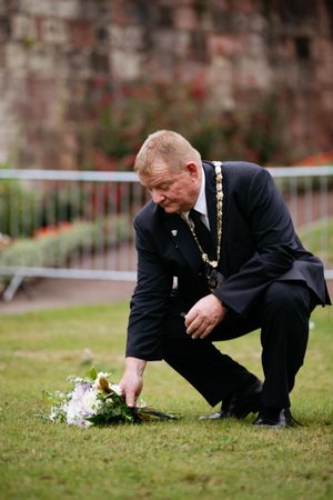 Councillor Vince Hunt, chairman of Shropshire Council, lays flowers at Shrewsbury Castle
