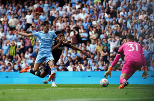 Manchester City's John Stones and Aston Villa's Ollie Watkins (centre) battle for the ball during the Premier League match at The Etihad Stadium, Manchester. Picture date: Sunday May 22, 2022. PA Photo. See PA story SOCCER Man City. Photo credit should read: Martin Rickett/PA Wire...RESTRICTIONS: EDITORIAL USE ONLY No use with unauthorised audio, video, data, fixture lists, club/league logos or "live" services. Online in-match use limited to 120 images, no video emulation. No use in betting, games or single club/league/player publications..