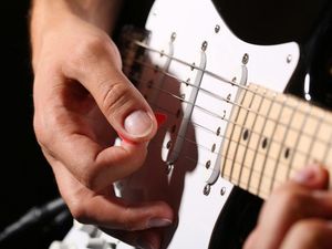 Supporting image for story: You need to hear this guy playing guitar to people driving past his house