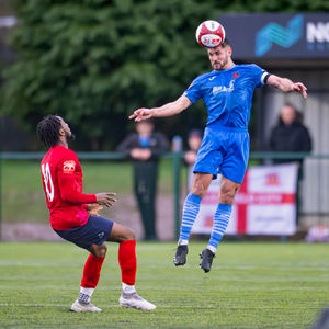 Lichfield City vs St Neots Town Feb 21st 2026. Leighton McMenemy wins the header. Pic: Jim Wall