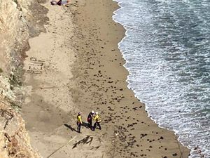 Supporting image for story: Kite surfer rescued from remote US beach after making ‘help’ sign with rocks