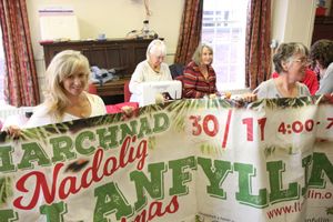 Volunteers use sewing skills to repair Llanfyllin's Christmas banner