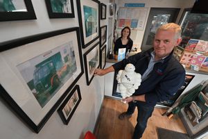 Managing director Peter Bayliss and his daughter Charlotte Bayliss looking at old pics on the wall at Bayliss Garages in Smethwick