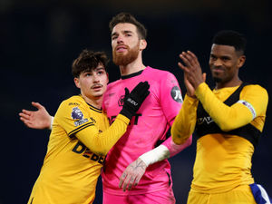  Rodrigo Gomes of Wolverhampton Wanderers hugs teammate Jose Sa at the end of the Premier League match between Chelsea FC and Wolverhampton Wanderers  (Photo by Jack Thomas - WWFC/Wolves via Getty Images)