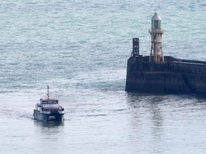 A group of people thought to be migrants are brought in to Dover (PA)