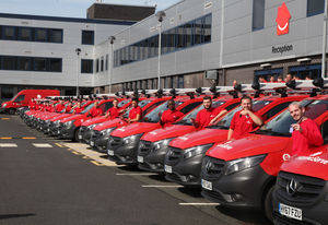 Newly qualified HomeServe apprentice engineers with their vans