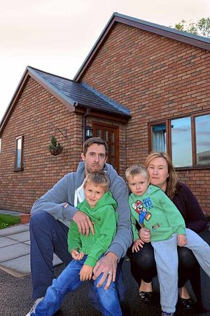 The family pictured outside their home
