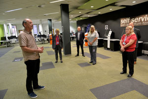 Vice chancellor Geoff Layer talks with staff
