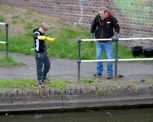 Scott Hargood looks on while McKenzie fishes in the canal
