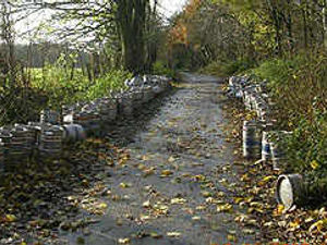 Supporting image for story: Lane flytippers left 150 beer barrels