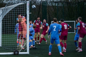 Telford Town goalkeeper Jack Chidlow punches the ball clear under pressure from Dawley Town's Dan Beddows Picture: Alan Hayward