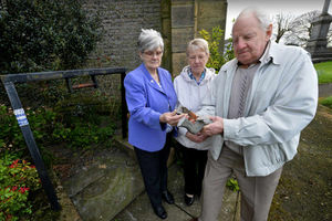 Gwen Taylor, Chris Gillam and Alan Taylor with what remains of the bell