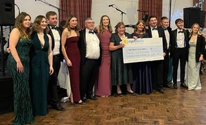 some of the Young Farmers involved in the organising with Sue Roberts holding the cheque with Karen Roberts