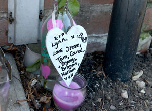 A note left with roses and a candle at the scene