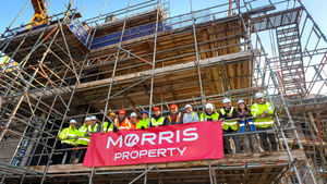 Staff from Concord College and Morris Property hold a topping out ceremony on projects to create new a residence and sports hall at the college in Acton Burnell
