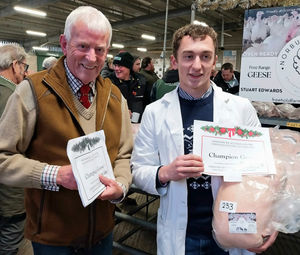 Show judge Alan Tomlinson (left) and Sam Edwards from Norbury Turkeys with the champion goose