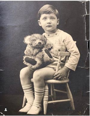 George Harwood in the same position as his grandfather, Alfred, with the same teddy bear - 86 years apart
