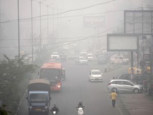 Commuters drive through a thick layer of smog in New Delhi