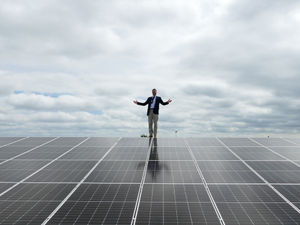 Supporting image for story: Telford teacher climbs onto school sports hall roof to celebrate solar panel project