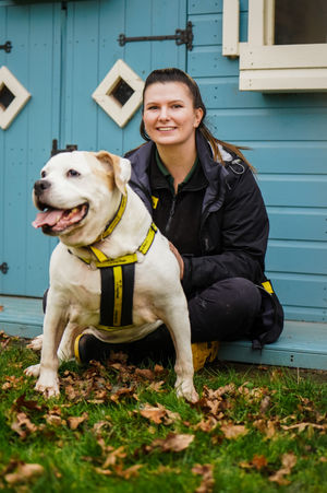 Tia is pictured with canine carer Elizabeth Terry
