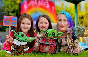 Laura McClure and daughters Elana and Willow with the colourful signs.
