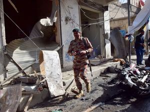 Security official checks at the site of a bomb blast in Quetta, Pakistan