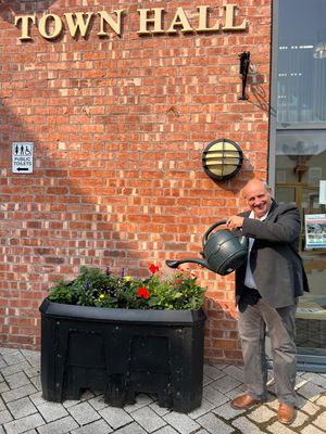 Market Drayton Mayor Tim Manton is urging residents, businesses and schools to take part in the town's bloom competition. 
