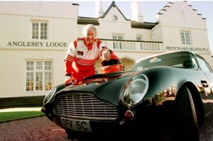 Fred in racing gear with his Aston Martin