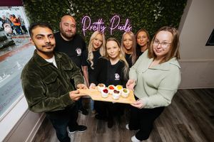 Pretty Puds in Newport is being handed over to new owners. Pictured is Samantha Parker (middle) handing over the business to Akshay Sharma and Katie Sharma