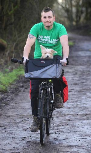 Wolfie rides in a special dog carrier on the front of the bike