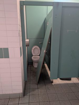 A cubicle door was smashed down.