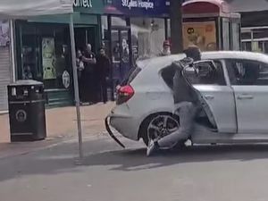 Supporting image for story: Shocked shoppers in Bilston caught masked men on camera speeding off in a car after loading it with baggage from outside a pawn shop