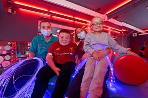 Brothers Riley and Jensen Harlock, with Sarah Daniels and Sarah Pollitt in the newly refurbished sensory room at Hope House.