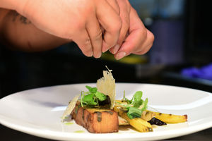 A medley of braised heritage carrots served with basil pesto, pomme anna potato and pecorino crisps