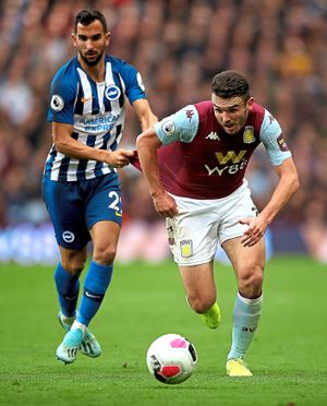 Brighton and Hove Albion's Martin Montoya (left) fouls Aston Villa's John McGinn (right) 