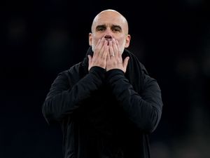 Pep Guardiola celebrates in front of the fans