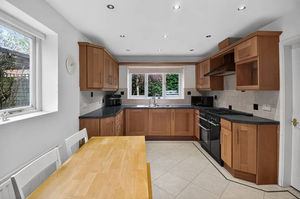 The open-plan kitchen and dining area forms the heart of the home, designed for modern living with space for everyday meals and hosting