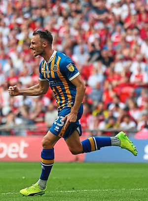 Alex Rodman wheels away in jubilation after hauling Town level (AMA)