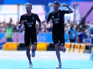 Dave Ellis, left, and guide Luke Pollard on their way to winning gold in Paris. Photo: Zac Goodwin/PA