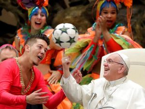 Pope Francis twirls a football presented by a member of the Circus of Cuba, during his weekly general audience in the Vatican in 2019