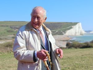Supporting image for story: King dons sturdy shoes on trek to mark launch of coastal path and nature reserve