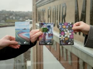 Three hands holding three building society passbooks, each feature a different design