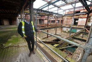 Hiten Raghwani stands on the first floor, at the top of where the escalator once was