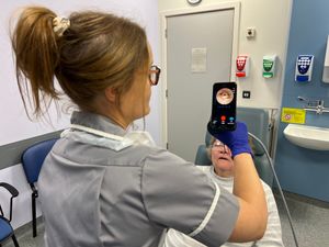 Nurse using the endoscope-i adapter on a patient